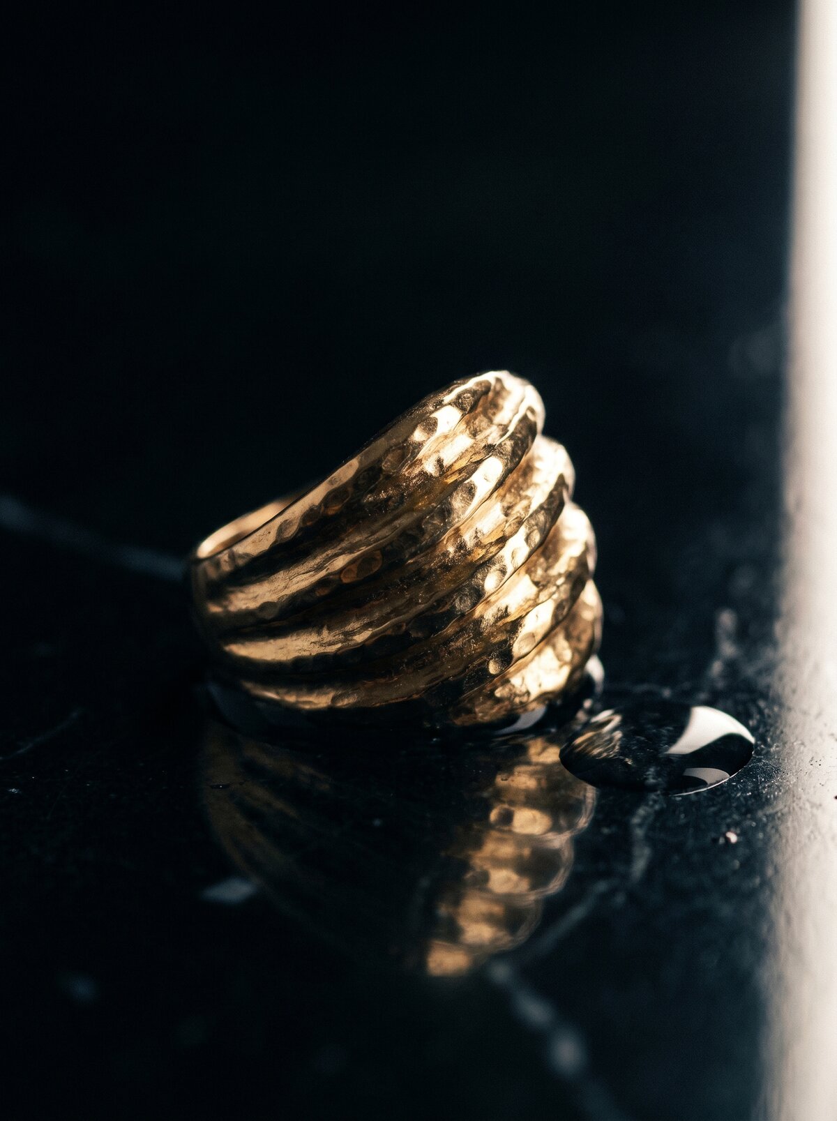 Gilded, gold rings macro on a dark reflective surface