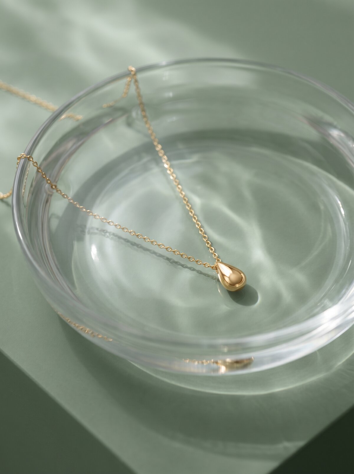Everyday Luxury, necklace submerged in a glass of water